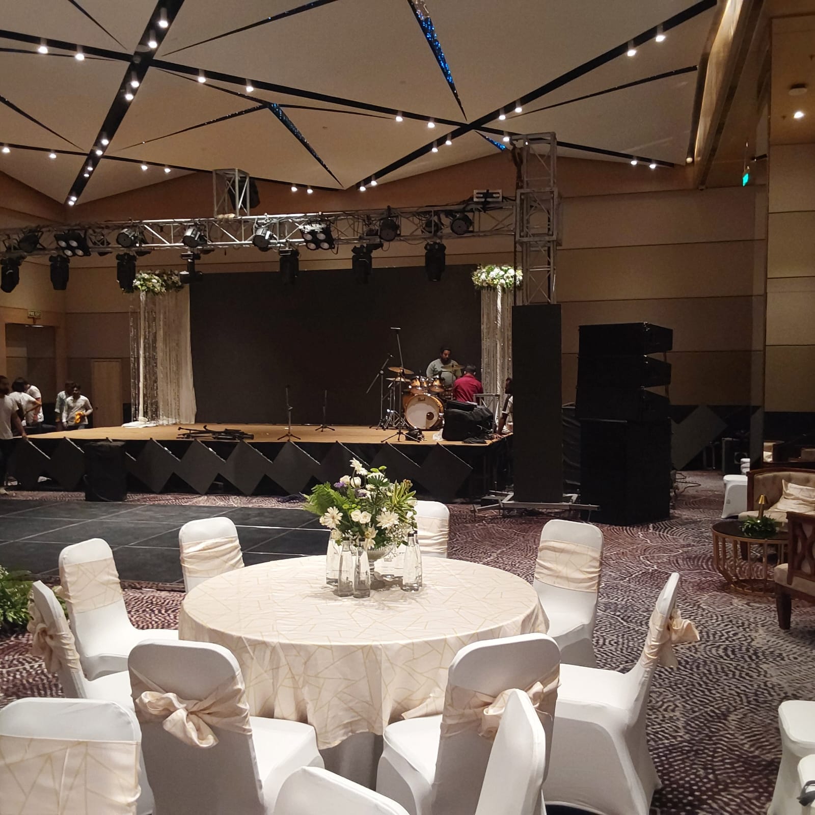 Banquet tables arranged with floral centrepieces before guests arrive