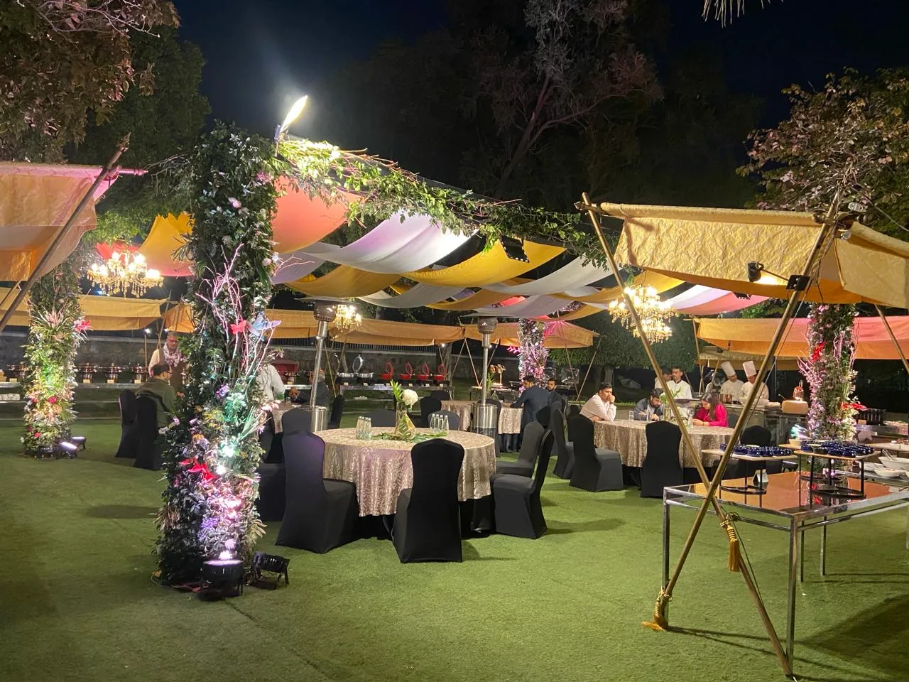An outdoor evening birthday party with canopied seating