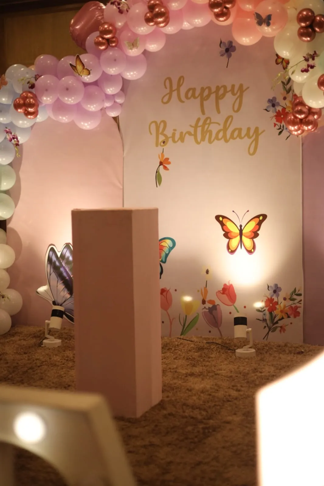 A pastel birthday backdrop with butterfly details
