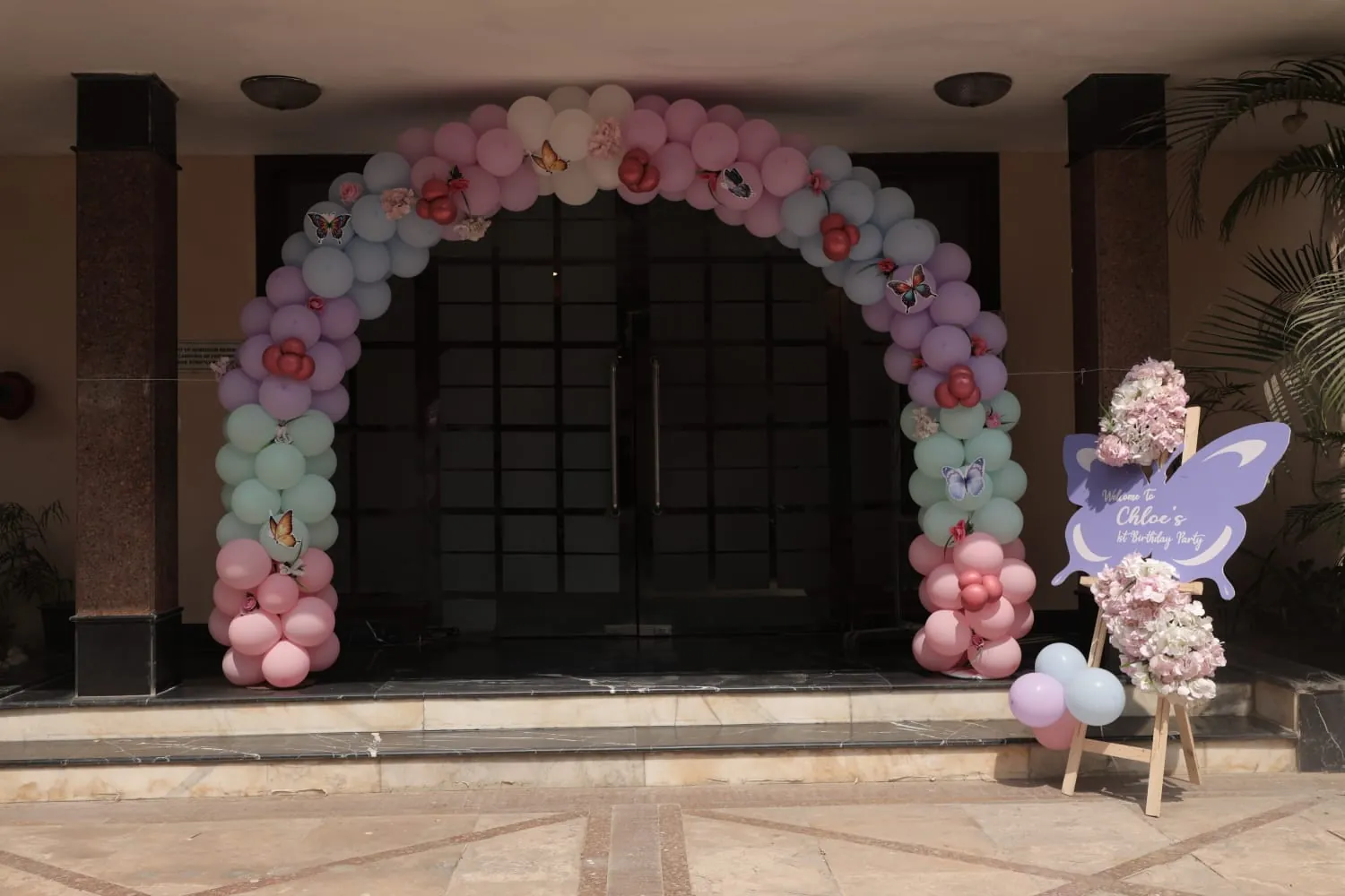 A pastel balloon arch framing an entrance