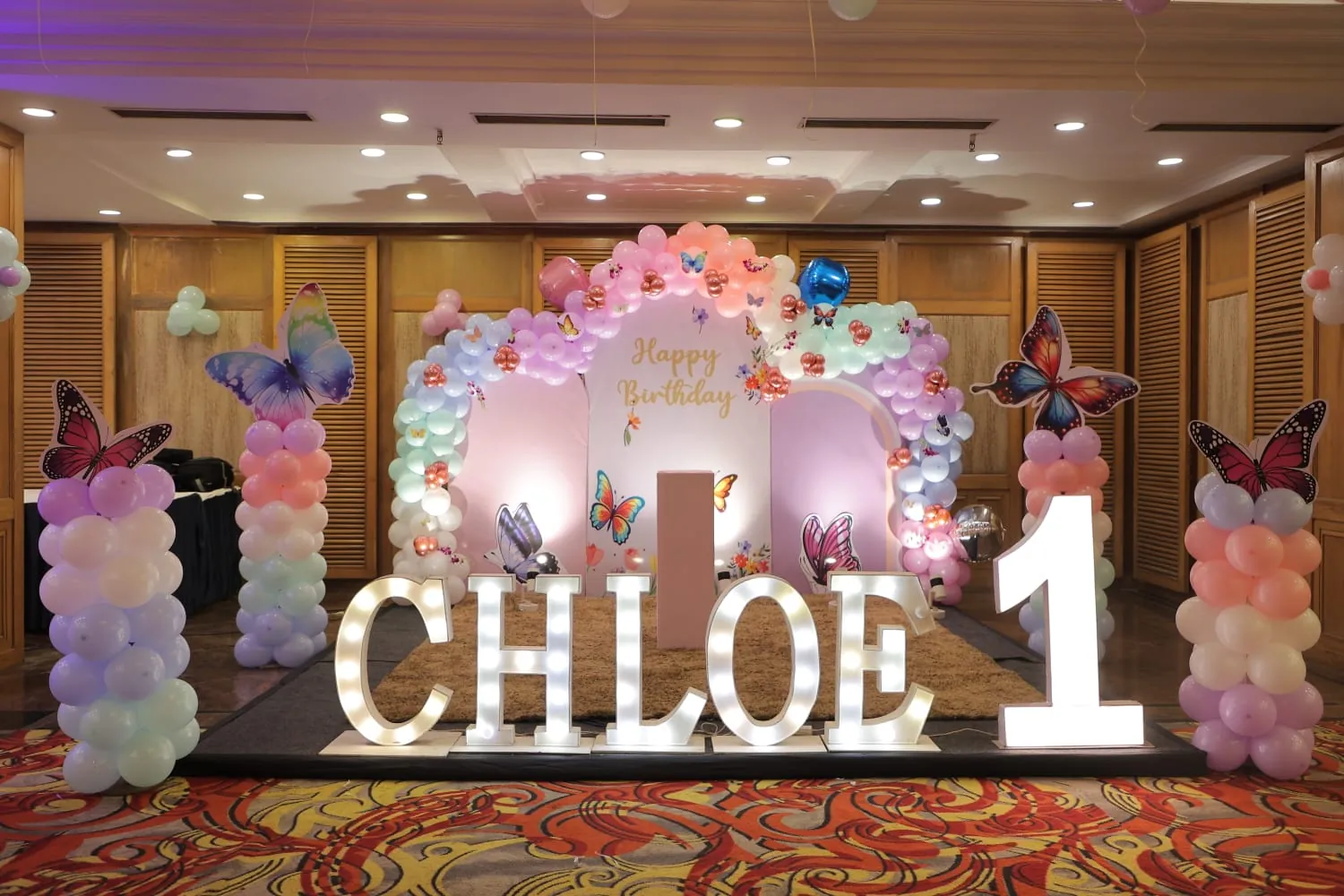 An illuminated name display at a first-birthday celebration