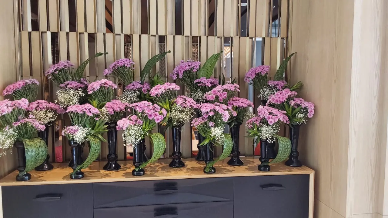Tall floral installations arranged for a corporate lobby
