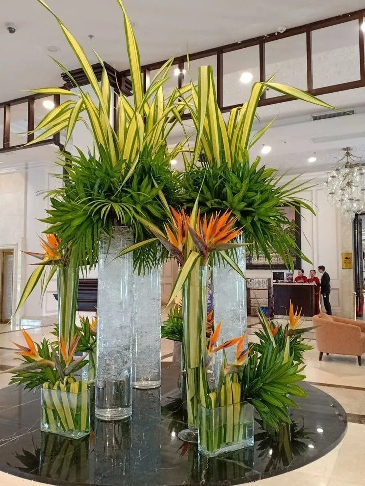 A tall floral installation arranged inside a corporate lobby