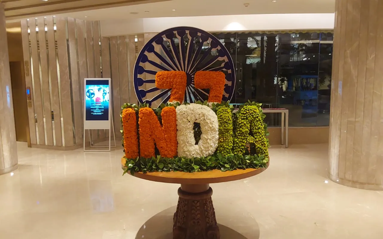 A floral installation spelling INDIA in a commercial lobby