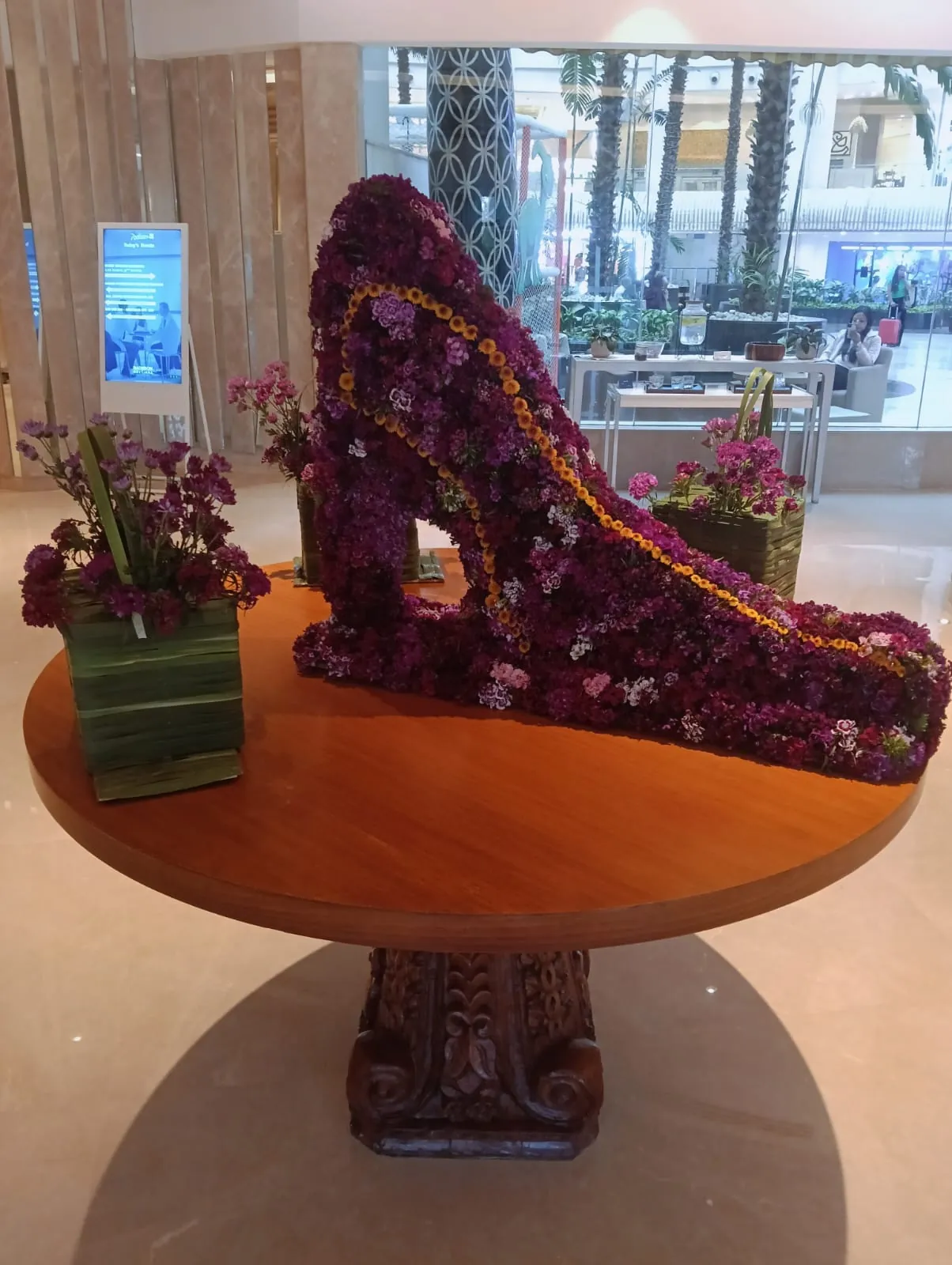 A layered flower arrangement displayed in a corporate common area