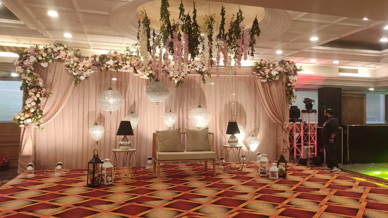 A floral wedding stage with softly lit seating