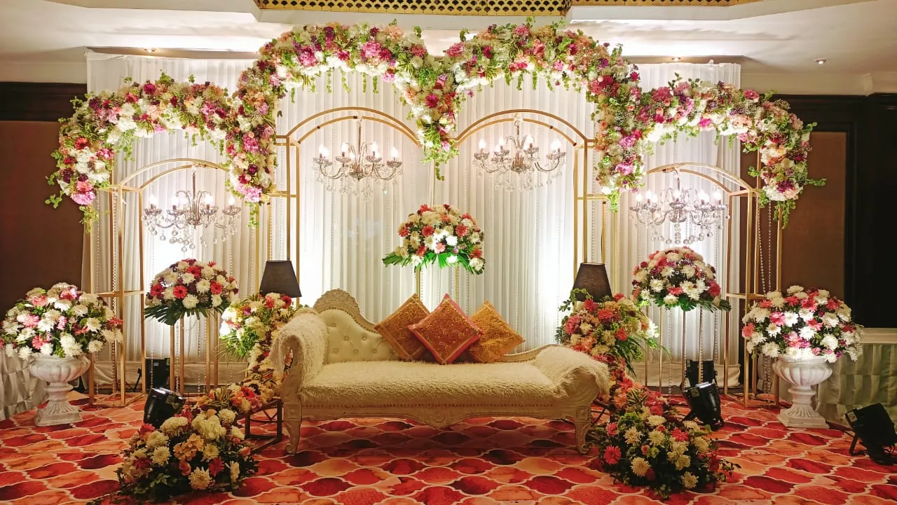 A wedding stage with layered floral detail and warm lighting