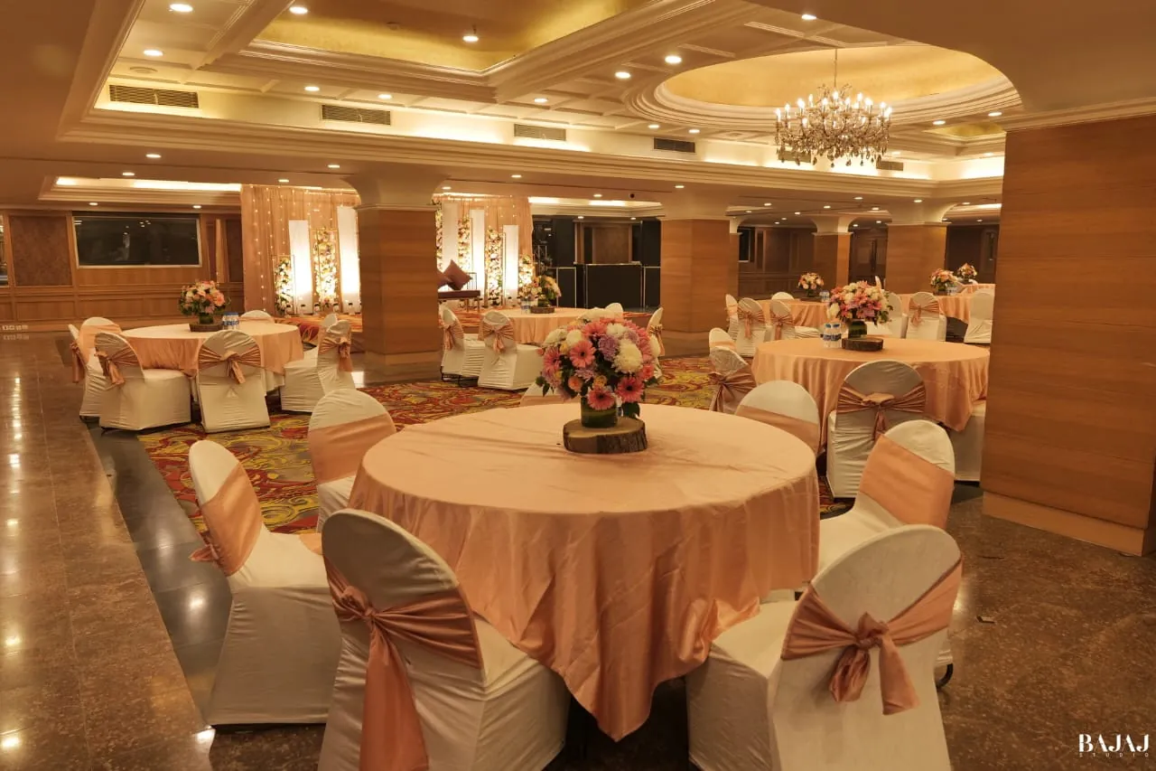 A banquet hall laid with round guest tables before a function