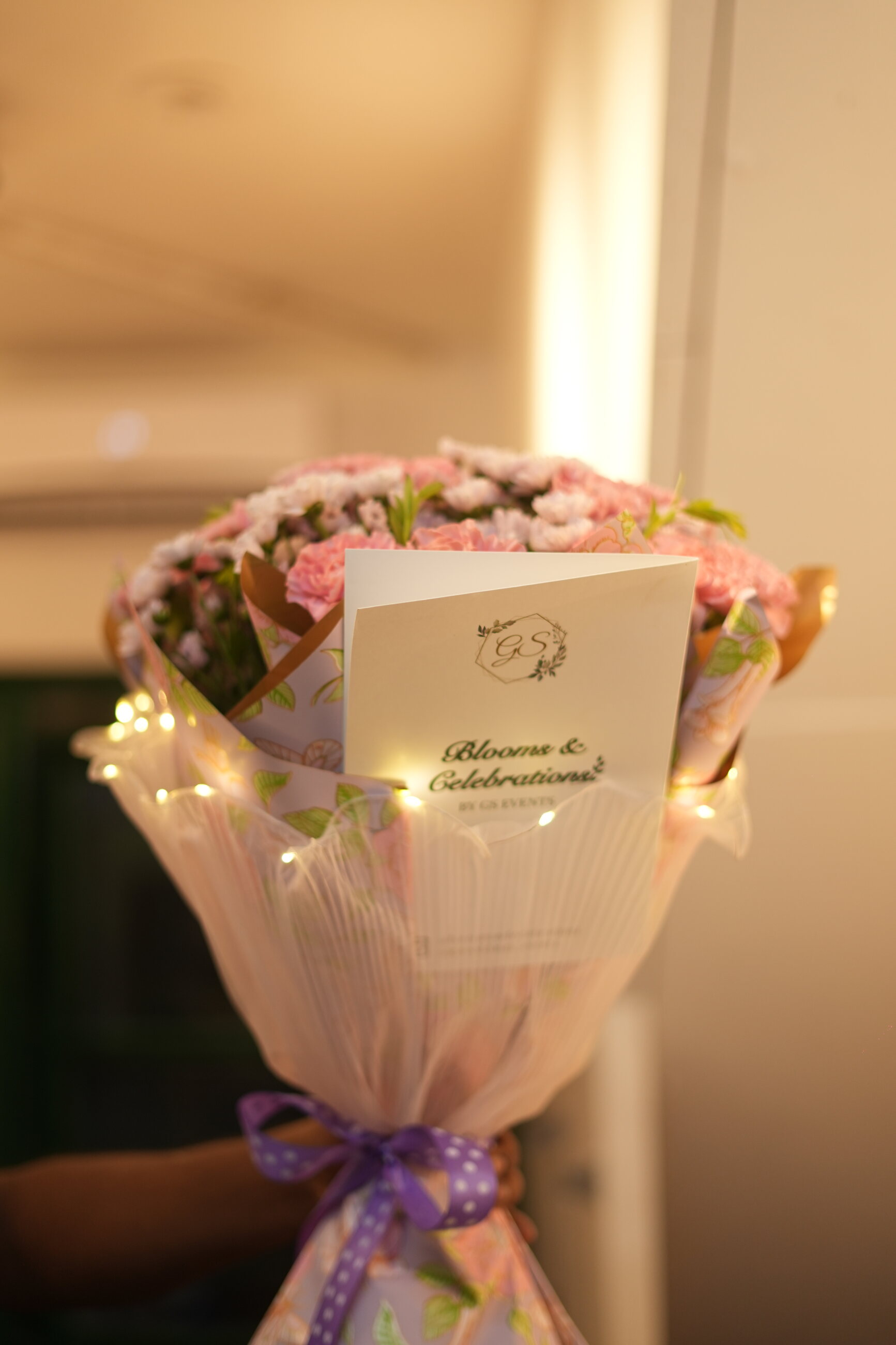 A blush pink bouquet wrapped in soft paper
