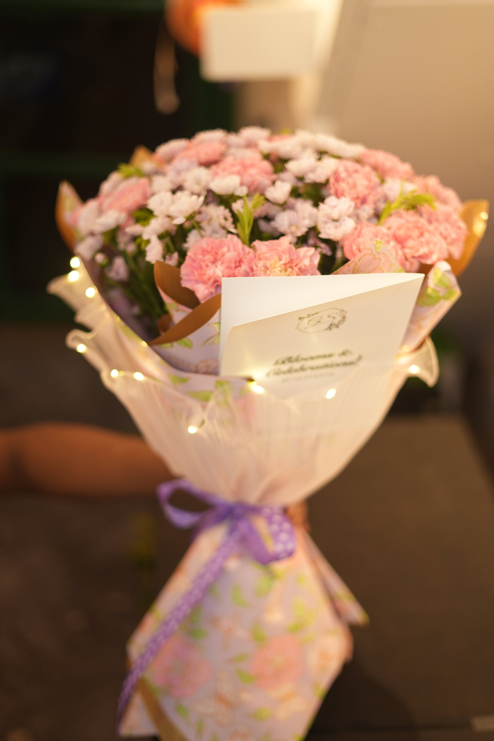 A soft pink bouquet wrapped in mauve paper